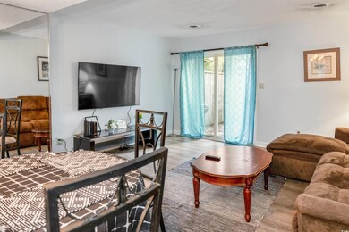 Bedroom featuring wood finished floors, access to outside, and baseboards