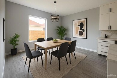 Dining space featuring a chandelier, dark wood finished floors, and baseboards