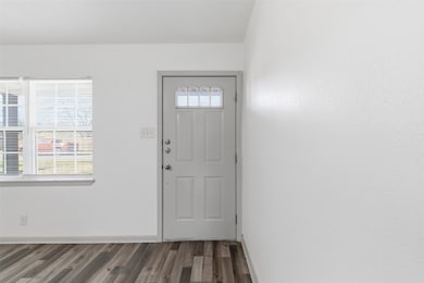 Foyer entrance featuring plenty of natural light and wood finished floors