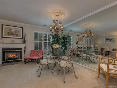 Dining Area Features Designer Chandelier and Mirro