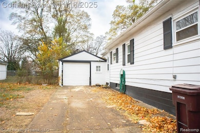 View of home's exterior featuring an outbuilding, driveway, and a detached garage