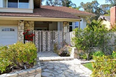 Flagstone front walk leads to a gated courtyard en