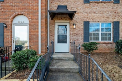 Doorway to property featuring brick siding