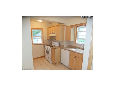 Kitchen features ceramic tile flooring, neutral de
