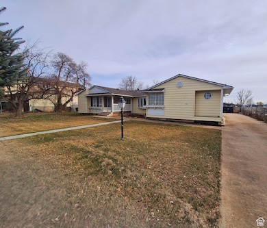 View of front of house featuring driveway and a front lawn