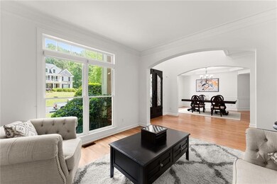 Living area / Den featuring arched walkways