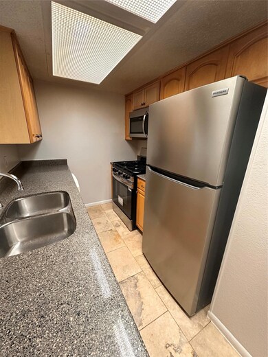 Kitchen featuring refrigerator, stainless steel g