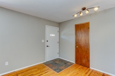 the gleaming wood floors and the coat closet is ad