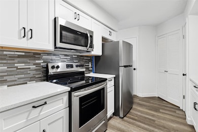 Kitchen featuring light stone counters, tasteful b