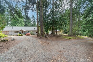 View of home from Thomas St showing driveway to home and to shop.
