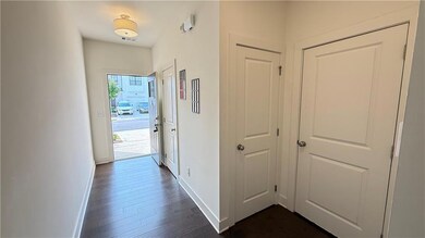 Hallway featuring baseboards and dark wood finished floors