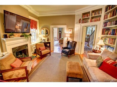Family room has hardwood floor, 4 member crown molding, built-ins and fireplace with mantel and surround marble.