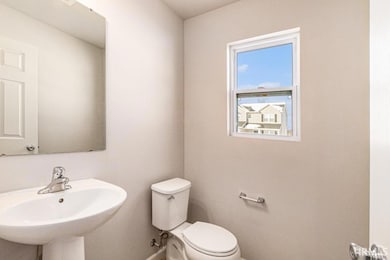The powder room is located toward the front of the