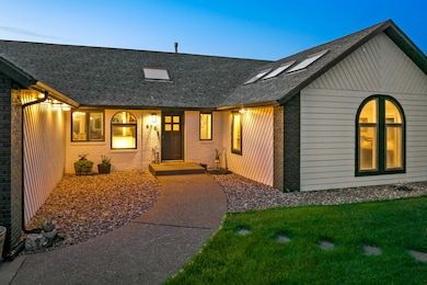 View of front of home featuring brick siding, roof with shingles, and a front lawn