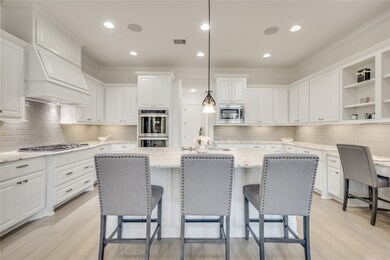 This kitchen is by far any chef’s dream! This spacious kitchen features white stained wood cabinets, leather granite countertops, SS appliances, modern tile backsplash, recessed lighting with additional custom pendant lighting, extended counter space, large island with space for breakfast bar, and a walk-in pantry all overlooking your huge family room.
