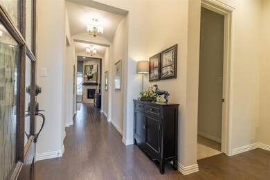Corridor with an inviting chandelier, lofted ceili