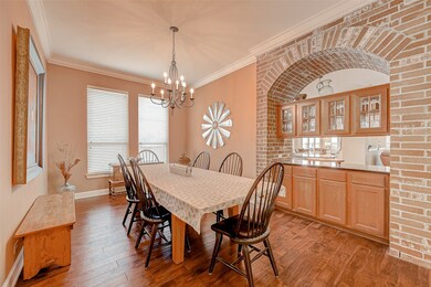 Notice the stunning cabinetry under the brick arch. The counter you see separates the dining room and living space and serves as a pass-through.
