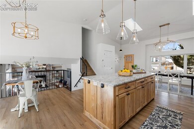 Kitchen featuring a chandelier, high vaulted ceili