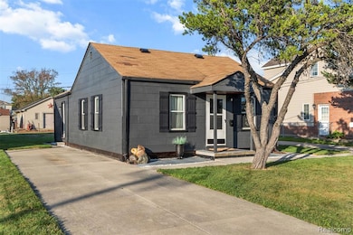 Bungalow-style house with a front lawn and roof with shingles