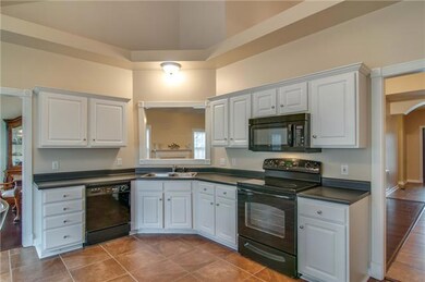 Plenty of cabinets and new tile flooring in this lovely eat in kitchen. New garbage disposal. Refrigerator remains.