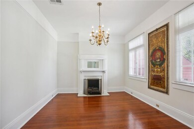 Living room with fireplace, chandelier & wood floo
