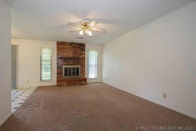 Living room is spacious and light, with wood burni