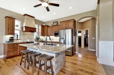Kitchen and dining have maple hardwood flooring. E