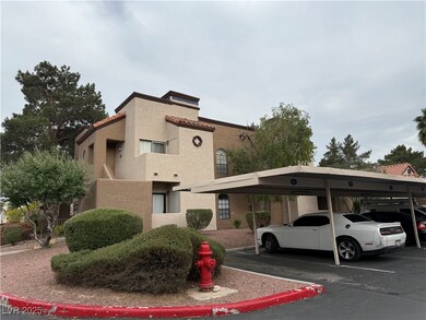 View of property with covered parking