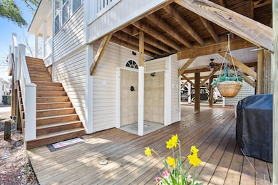Wooden terrace with a grill and stairs