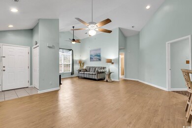 Living room featuring light hardwood / wood-style flooring and high vaulted ceiling