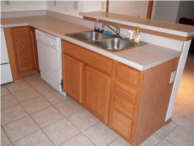 Tiled floor in the kitchen, and lots of cabinet an