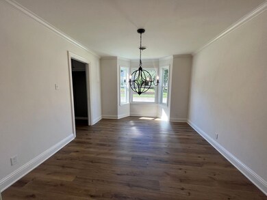 Unfurnished dining area featuring dark wood-type f
