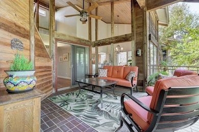 Sunroom / solarium with healthy amount of natural light and a chandelier