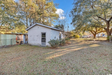 Back of property featuring a lawn