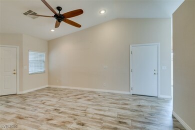 Living room featuring a ceiling fan, baseboards, l