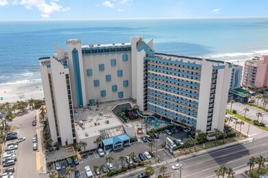 Birds eye view of property with a water view and a