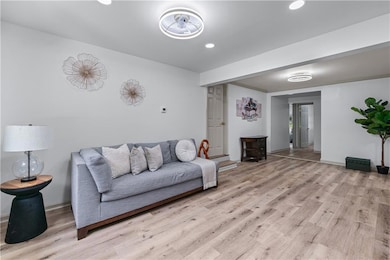 Living area featuring light wood-type flooring, recessed lighting, and baseboards