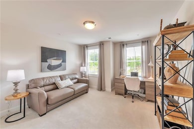 This versatile bedroom offers carpet flooring and ample closet space, making it ideal for use as a comfortable home office or guest room.