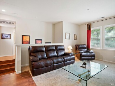 Living room. Stairs going down to the entrance are behind the couch.