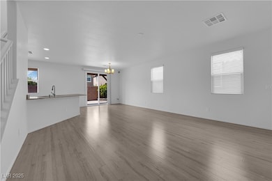 Unfurnished living room with a chandelier, stairwa