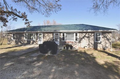 Mature trees shade the two-unit duplex.