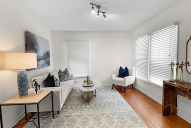 Living area featuring light wood-style flooring and baseboards