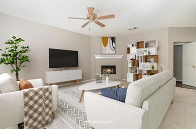 staged Living room featuring ceiling fan