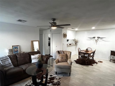 Living room with wood finished floors and ceiling fan