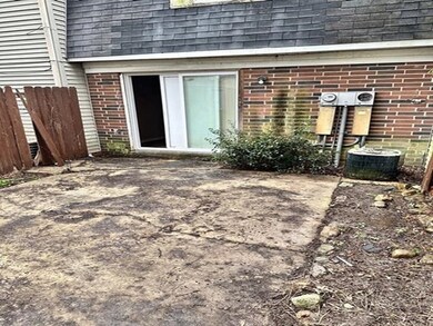 Entrance to property with brick siding and a shingled roof