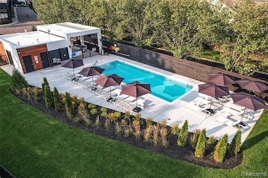 Community pool featuring a fenced backyard and a patio area