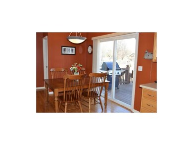 Dining area with HARDWOOD FLOORS looks out to the 
