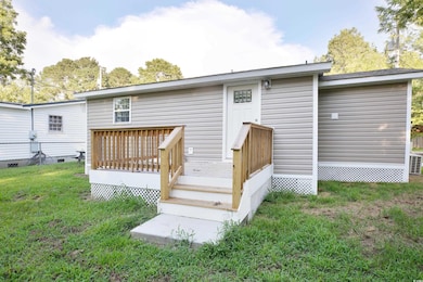 Rear view of house with a deck
