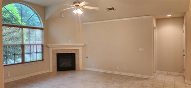 Unfurnished living room with a tiled fireplace, ce