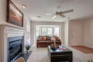 Living room is complete with fireplace, recessed accent light over fireplace mantle and lighted ceiling fan for comfort. 